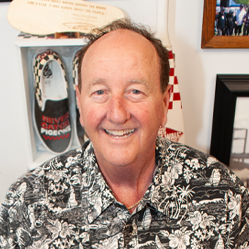 man smiling in haiwaiin shirt