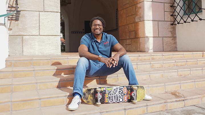 man sits with skateboard